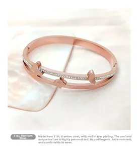 Close-up of rose gold butterfly bangle with double row crystals in 316L titanium steel