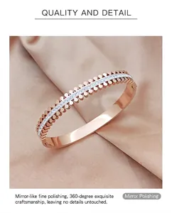Macro shot of rose gold bangle with two rows of round studs and inlaid white zircons