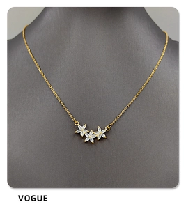 Detail of gold star pendant necklace with marquise white zircon inlay for women
