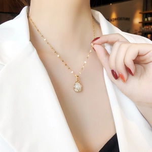 Elegant gold titanium necklace featuring a tulip cat's eye stone pendant with zircons