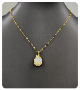 Detailed view of tulip pendant with opal stone and diamonds on a gold chain