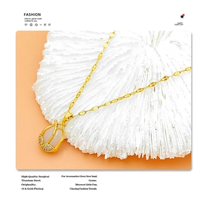 Detail view of 18k gold plated titanium steel necklace with cat-eye tulip pendant