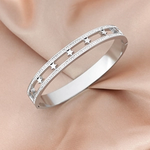 Elegant silver star hollow bangle with two rows of crystals on champagne silk background