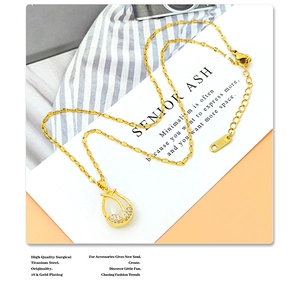 Detail of 18K gold plated tulip pendant featuring cat eye stone and tiny crystals