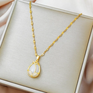 Golden titanium steel tulip necklace with cat-eye stone on champagne silk background