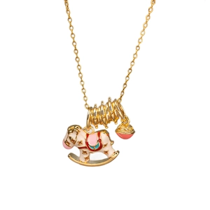 Golden enamel rocking horse necklace with red bell pendant on a white background