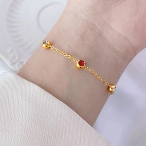 Exquisite 18K gold-plated titanium steel bracelet featuring red and white zircon accents