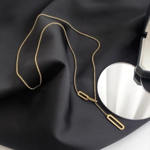 Adjustable gold plated Y-necklace with geometric paperclip chain pendants on black silk