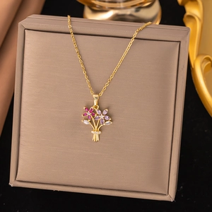 Close-up of golden floral bouquet pendant with pink and purple marquise-cut zircons