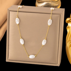 Golden pearl necklace featuring white oval pearls on a delicate gold chain for women