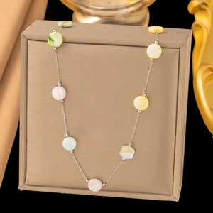 Detail of colorful shell charms on a polished stainless steel long chain necklace