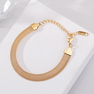 Detailed close-up of 18K gold woven mesh bracelet with lobster clasp and extension chain