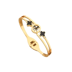 Golden double-layer clover bangle with black inlay and diamonds on a white background