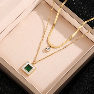 Luxury double-layer gold necklace with emerald square pendant and round crystal accents
