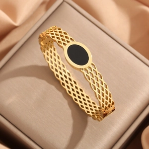 Vue détaillée du bracelet en acier inoxydable doré avec motif évidé et pierre noire ovale