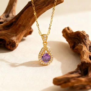 Elegant gold teardrop necklace featuring a purple zircon pendant on a dainty chain