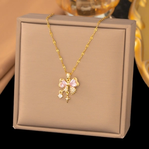 Makroaufnahme einer goldenen Schleifenhalskette mit rosa Herzsteinen und Zirkonia-Akzenten