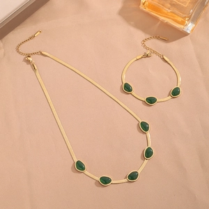 Vintage gold blade chain jewelry set with emerald drop charms including necklace and bracelet