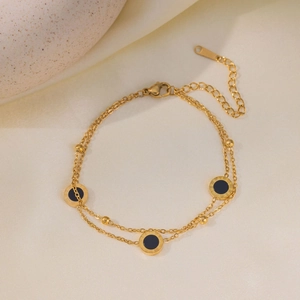 Double-layer gold titanium steel anklet featuring black Roman numeral coin charms
