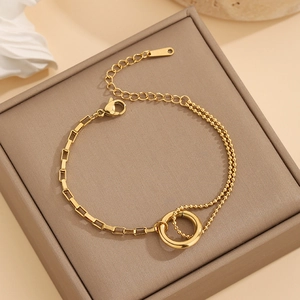 Asymmetric gold-plated titanium steel bracelet featuring round circles and mixed chain links