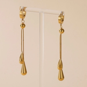Elegant gold-plated titanium steel water drop tassel earrings on a display stand