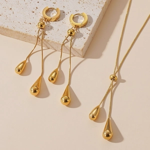 Elegant gold teardrop tassel necklace and earring set in polished stainless steel
