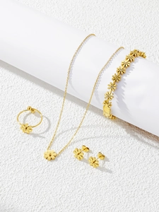 Detailed view of 4-piece gold daisy jewelry set including necklace and earrings