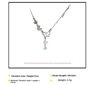 Détail du collier papillon argenté avec zircons brillants et chaîne en acier titane