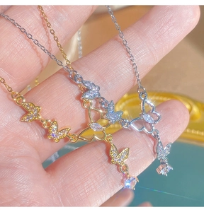 Détails de colliers papillon en or et argent avec de l'oxyde de zirconium étincelant