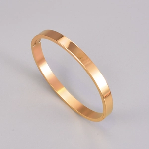 Detail view of mirror-polished rose gold titanium steel bracelet with hinge clasp