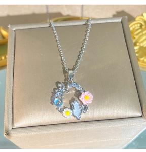 Dettaglio del ciondolo a ghirlanda floreale con gattino e strass su catena a O