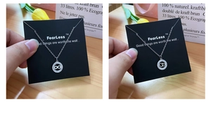 Detail of silver infinity and interlocking hearts necklaces with sparkling crystals