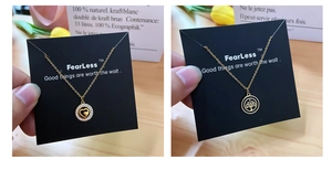 Detailed close-up of gold-plated heart and tree of life pendants with diamond accents