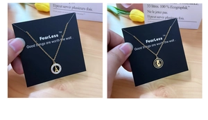 Detail of gold heart pendant necklace on display card with tulip decoration
