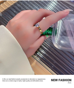 Detail of elegant gold titanium steel ring featuring a large round zircon stone