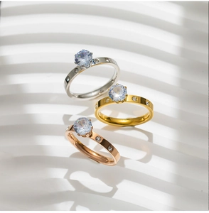 Detailed view of six-prong solitaire rings in silver, gold, and rose gold finishes