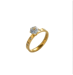 Close-up of a gold titanium ring featuring a six-prong round zircon and small side stones