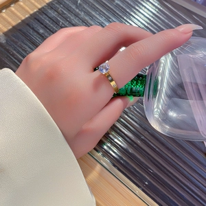 Elegant gold titanium steel ring with a large zircon solitaire and side accent stones