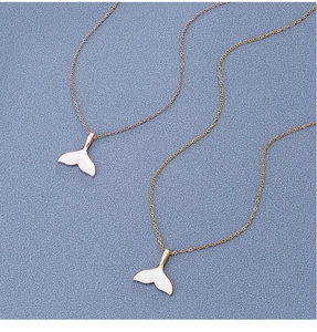 Detail view of 18k gold plated fisheye necklaces with white shell inlay details