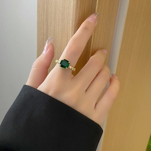 Elegant emerald green zircon ring with square cut stone and golden beaded bezel