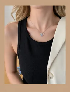 Detail of silver deer antler pendant necklace with round zircon on female model