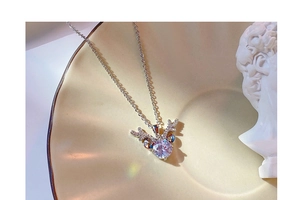 Detail view of antler pendant necklace with sparkling diamonds on a ceramic plate