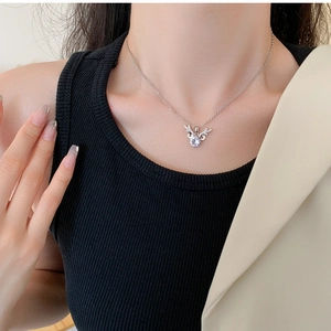 Macro shot of silver reindeer antler pendant necklace with sparkling zirconia stone