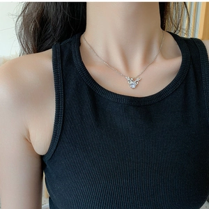 Close-up of silver antler pendant necklace with sparkling stone on female collarbone