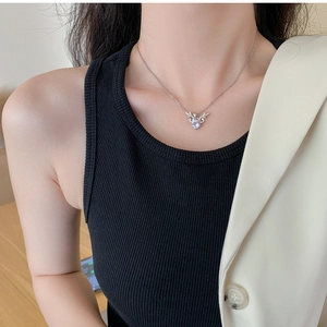 Detailed view of silver antler pendant necklace with sparkling crystal inlay on a model