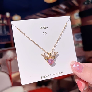 Elegant gold antler necklace with a pink heart pendant and sparkling zircon accents