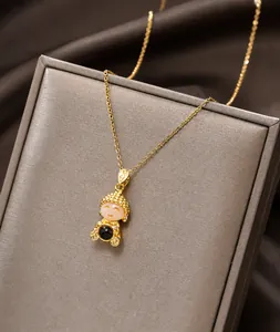 Macro shot of gold Buddha pendant with cat eye stone and detailed coin motifs