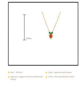 Macro view of carrot pendant with orange teardrop zircon and green leaves on gold chain