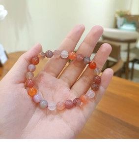Close-up of multi-color natural gemstone beaded bracelet with polished round crystal beads