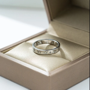 Silver titanium steel Roman numeral ring with inlaid crystal in a luxury jewelry box